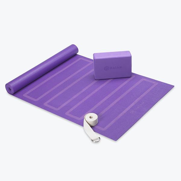 purple yoga mat with yoga block and yoga straps